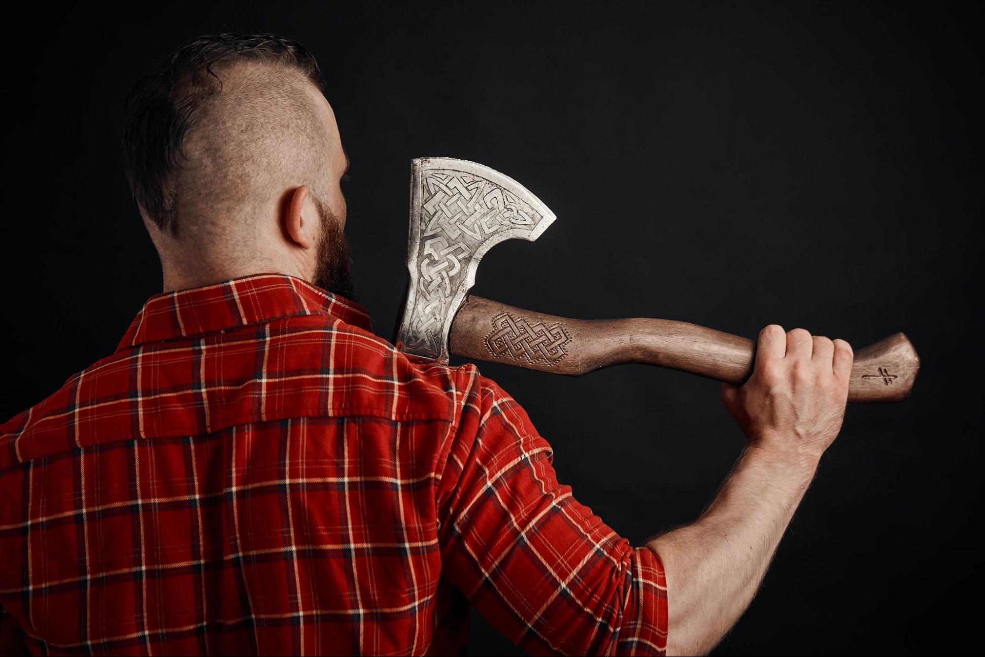 Man holding an axe from the back. 