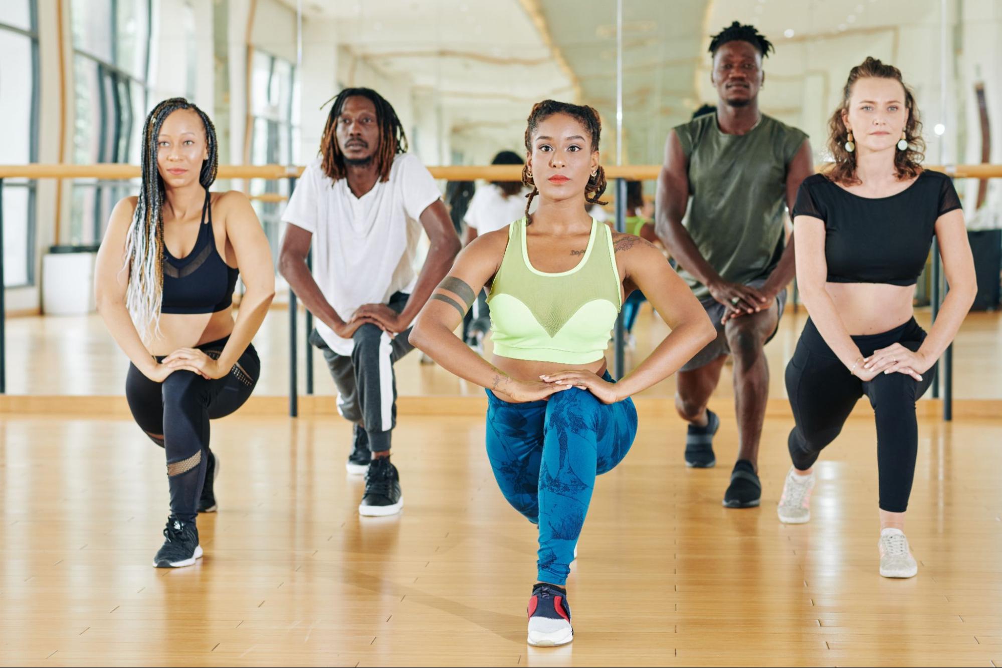 Men and women doing lunges. 