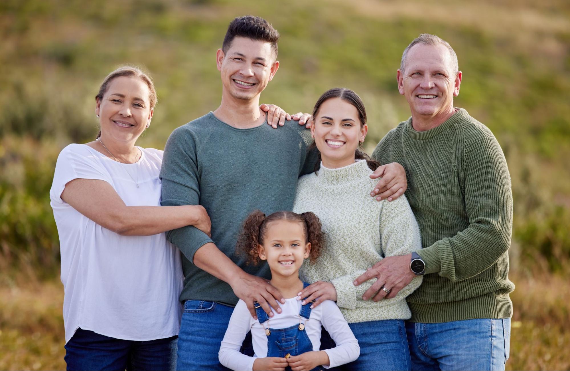 Multi-generational family standing outside. 