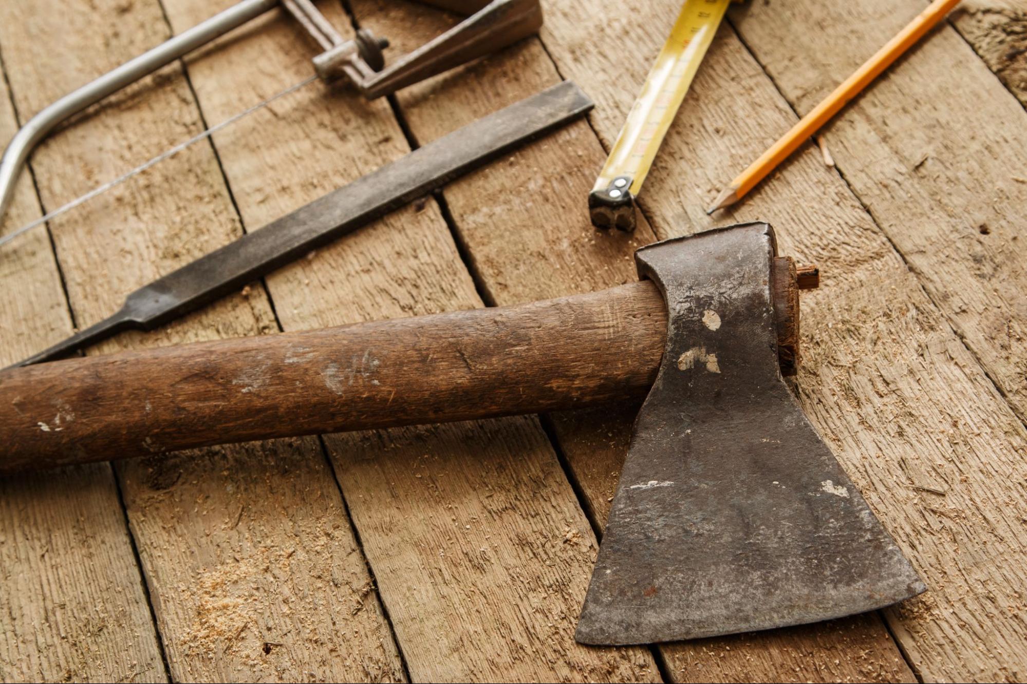 Axe with a wooden surface behind it. 