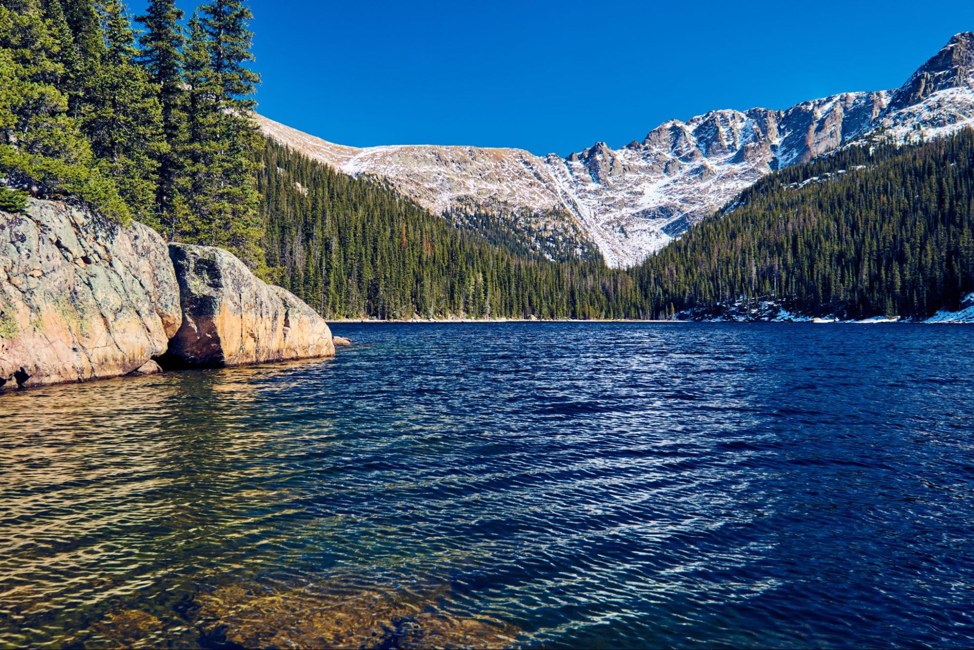 Lake Verna with rocks and mountains at Rocky Mountain National Park in Colorado, USA.
