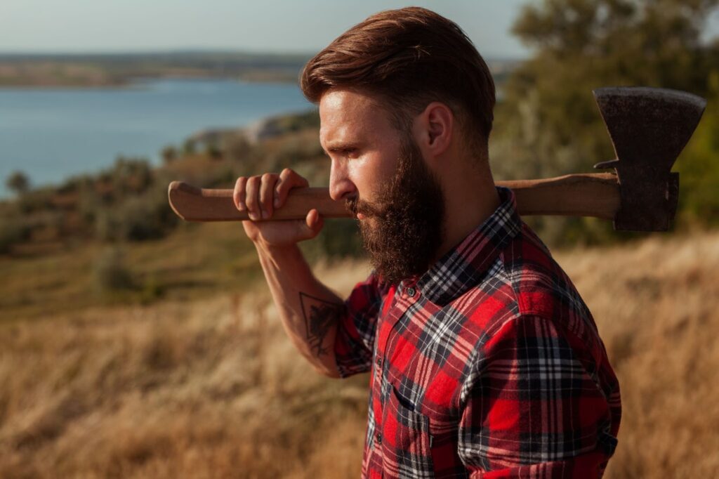 a person holding an axe over his shoulder