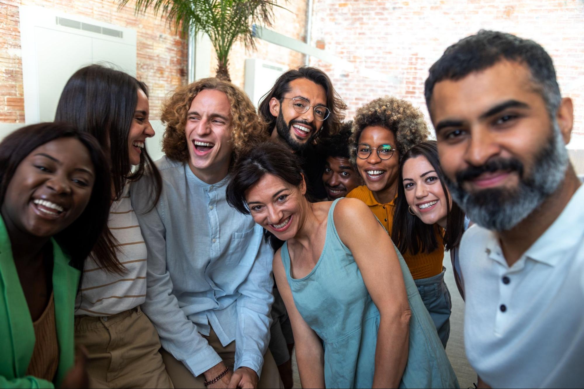 Group of smiling men and women hanging out. 