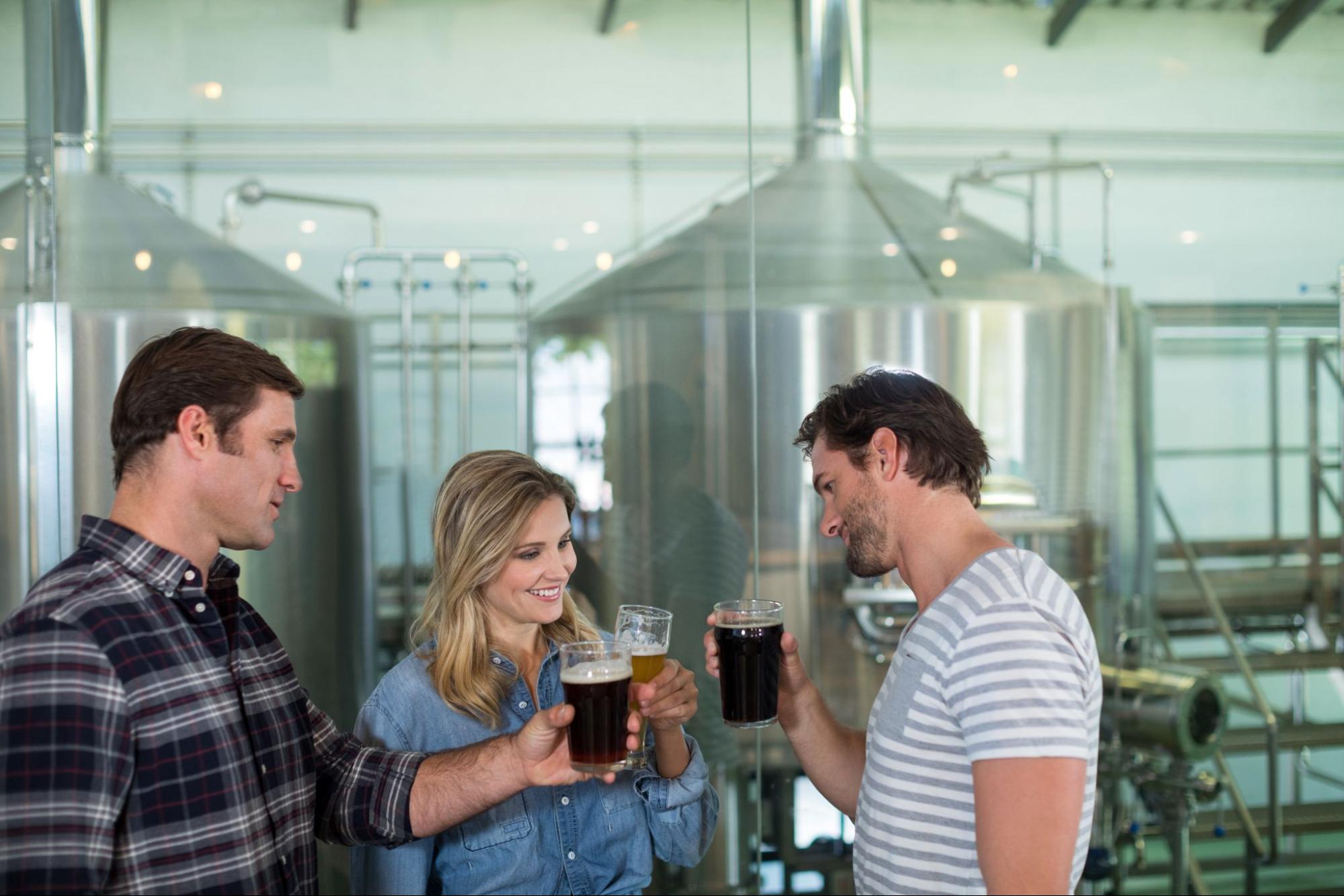 Friends drinking beer at a brewery.